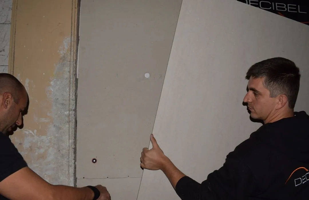 technicians installing wall insulation